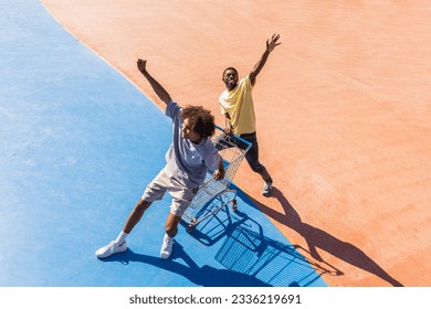 Multicultural group of young friends bonding outdoors and having fun - Stylish cool teens gathering at urban skate park - Shutterstock ID 2336219691