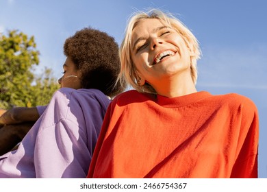 Multicultural group of young friends bonding outdoors and having fun - Stylish cool teens gathering at urban skate park - Powered by Shutterstock