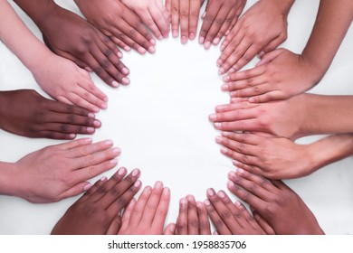 Multicultural hands and arms on a white backdrop in a heart shape Asian European African