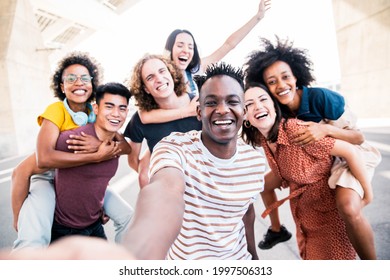 Multicultural Happy Friends Having Fun Taking Group Selfie Portrait On City Street - Young Diverse People Celebrating Laughing Together Outdoors - Happy Lifestyle Concept