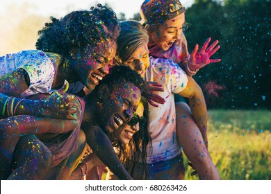 Multicultural Happy Friends Piggybacking Together At Holi Festival