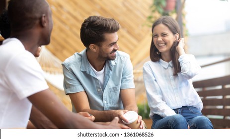 Multicultural happy people laughing at funny joke talking at reunion meeting on cafe terrace outdoor, cheerful diverse friends having fun drink coffee enjoy laughter, multi-ethnic friendship hangout - Powered by Shutterstock