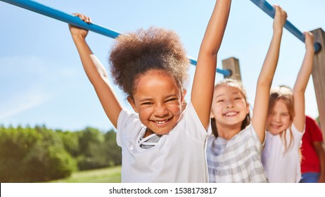 Multicultural Kids Shimmy On Jungle Gym On The Trim Path