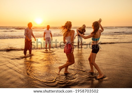 multicultural multinational happy people running into the sun carefree and happiness, vacation on sea