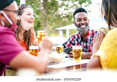 Multicultural People Drinking Beer With Open Face Masks - New Normal Gathering Concept With Friends Having Fun Together On Happy Hour At Brewery Bar - Bright Filter With Focus On Right Guy