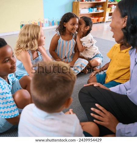 Multi-Cultural Primary Or Elementary School Class With Students Whispering To Each Other