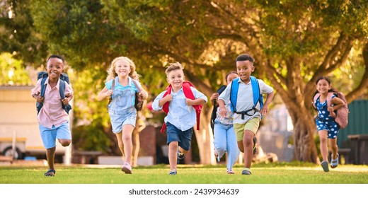 Multi-Cultural Primary Or Elementary School Students With Backpacks Running Outdoors At End Of Day - Powered by Shutterstock