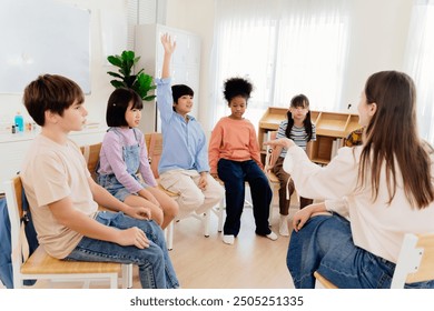 Multicultural primary school children participate in engaging group lesson. Teacher facilitates active learning through circular seating arrangement, encouraging student involvement and communication - Powered by Shutterstock