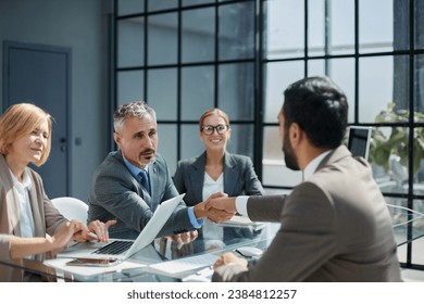 Multicultural professionals project managers group negotiating in boardroom at meeting.