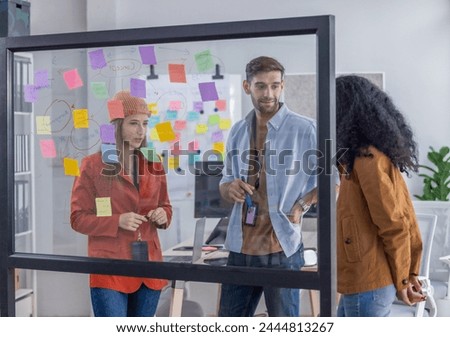 Multicultural startup team brainstorm, exchange ideas, develop fresh perspective by using sticky notes. Working collaboratively as a team help generate innovative idea, potential solution for company