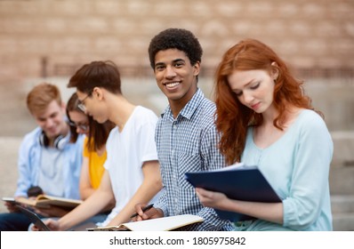 Multicultural Students Learning Preparing For Tests Sitting Outside University Building. Higher Education Abroad. Selective Focus