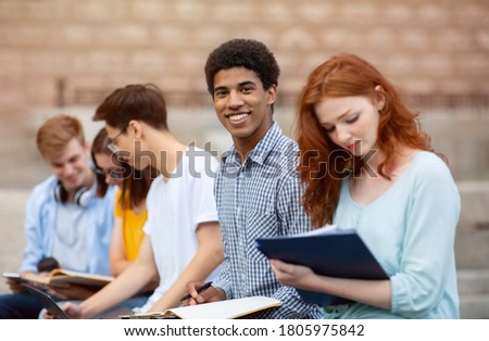Multicultural Students Learning Preparing For Tests Sitting Outside University Building. Higher Education Abroad. Selective Focus