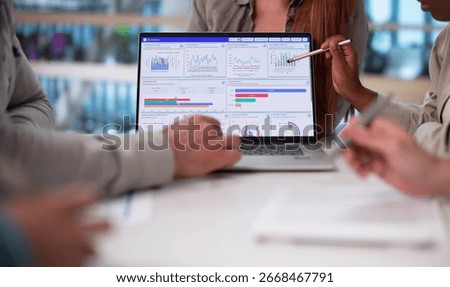 Multicultural Team Analyzing Demographic Data For Financial Predictions In Office