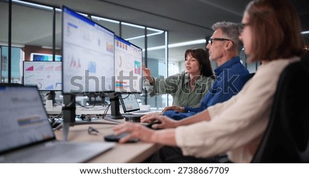 Multicultural Team Analyzing Performance Data Using KPI Dashboard In Office