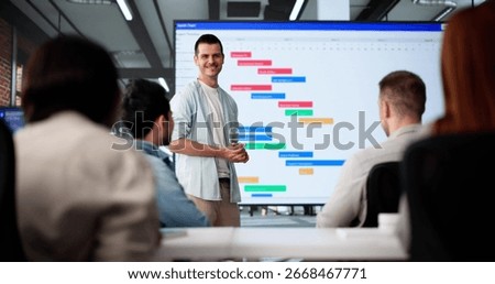 Multicultural Team Presenting Gantt Chart During Office Training Session