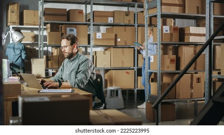 Multicultural Team Of Warehouse Employees At Work In Retail Shop's Storeroom. Small Business Owners And Inventory Managers Working On Laptop, Packing Parcels For Delivery.