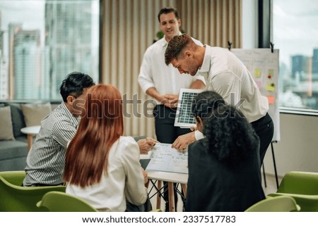In multicultural workspace, innovative project manager present sustainable solar panel product, fostering collaboration and diversity among colleagues, aiming for efficient, renewable energy solution