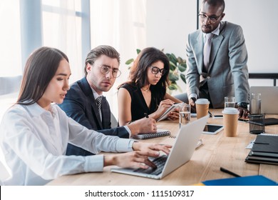 multicultural young business people having business meeting in office - Shutterstock ID 1115109317