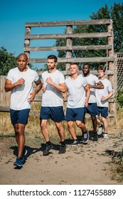 multicultural young soldiers running on range - Shutterstock ID 1127455889