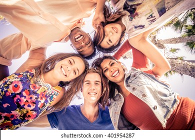 Multicutural group of young people having fun on a tropical beach - Friends on a summer holiday looking down at camera and laughing