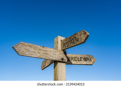 Multidirectional Wooden Signpost Showing Public Footpaths And Bridleways In The Rural Countryside