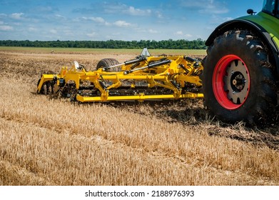 multi-disc cultivator, tillage system in operation with tractor - Shutterstock ID 2188976393