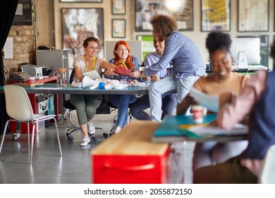 Multietchnic group of people working in groups in open space office, enjoining at work. Loving job concept - Shutterstock ID 2055872150