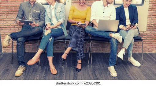 Multiethnic Asian Business Group In Casual Suit Using Smart Phone, Tablet And Laptop For Working Or Playing Social Network And Web Site In Modern Office. Business And Technology Concept