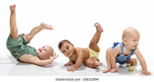 Multiethnic Babies Dancing On Light Background