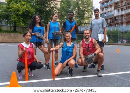 Multiethnic baseball team posing with their coach on the field before a game, holding bats, gloves, and wearing team uniforms, ready for the competition