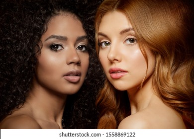 Multi-ethnic beauty. Caucasian and African. Different ethnicity women on black background. Beautiful vogue girls.