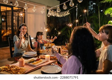 Multi-ethnic big family having fun, enjoy party outdoors in the garden. Attractive diverse group of people having dinner, eating foods, celebrate weekend reunion gathered together at the dining table. - Powered by Shutterstock