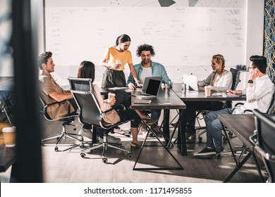 multiethnic business partners having meeting at table with laptops in modern office  - Powered by Shutterstock