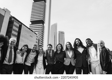 Multiethnic Business People Celebrating Outside Of The Office With City In Background - Focus On Center Faces - Black And White Editing