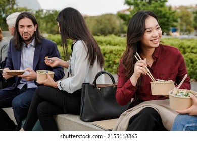 Multiethnic Business People Eating Takeaway Food During Lunch Break Outdoor Outside The Office - Focus On Asian Woman Face