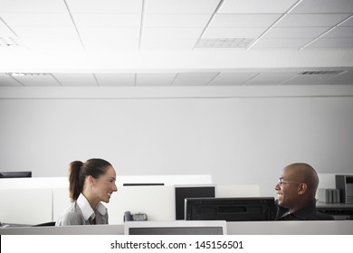 Multiethnic Business People Having Casual Meeting In Office Cubicle