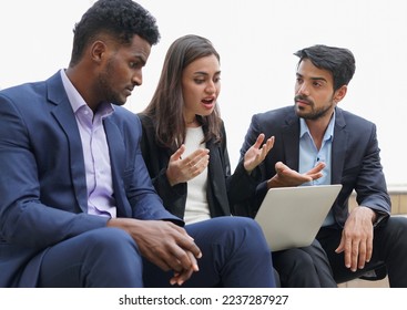 multiethnic business people in suits working outdoors site,sitting and working over the internet, businesswoman having conflict while discussing on laptop. concept conflict at work, managing conflict  - Powered by Shutterstock