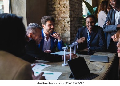 Multiethnic Business People Working On Sustainable Renewable Energy Project Inside Office - Green Alternative Electricity Concept