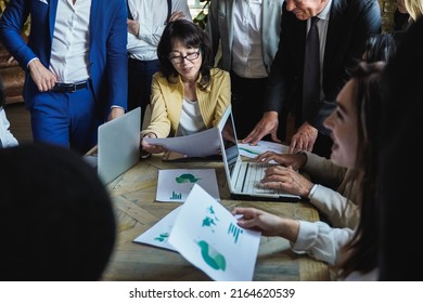 Multiethnic Business People Working On Green Sustainable Development Meeting Inside Modern Office - Focus On Asian Senior Woman