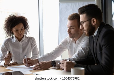 Multi-ethnic Business Team Brainstorming Doing Paperwork Analyzing Market Or Financial Data Report Gathered Together Sitting At Desk In Boardroom At Table In Office, Teamwork Corporate Meeting Concept