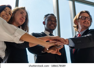 Multiethnic Business Team Including Man, Woman, African And Caucasian People Touch Hands As A Sign Of Integrity And Unity Of Corporate