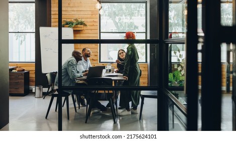 Multiethnic Businesspeople Having A Group Discussion During A Meeting In An Office. Team Of Diverse Businesspeople Sharing Creative Ideas In An Inclusive Workplace.