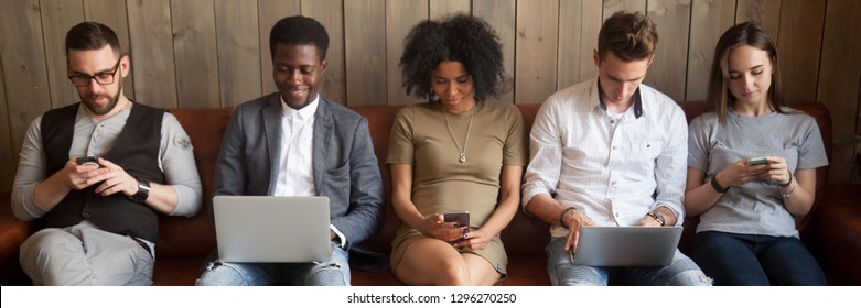 Multi-ethnic Businesspeople Sitting In Row On Couch Absorbed In Mobile Phones Computers Girls Guys Addicted In Gadgets Devices. Overuse Dependence On Internet Concept, Banner For Website Header Design