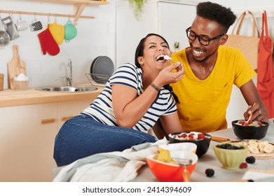 Multiethnic couple breakfasting together in the kitchen - Powered by Shutterstock