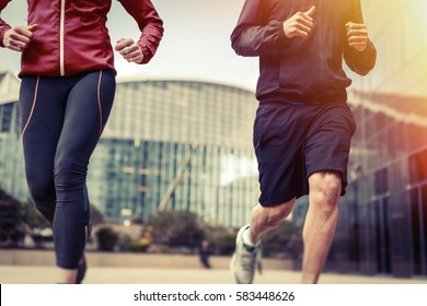 Multi-ethnic Couple Jogging In Urban Setting