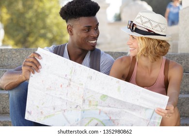 multiethnic couple looking at a map
