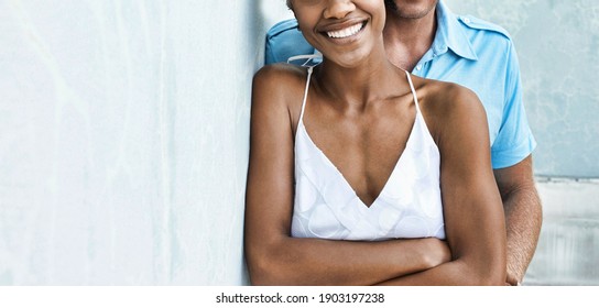 Multiethnic couple standing together against wall