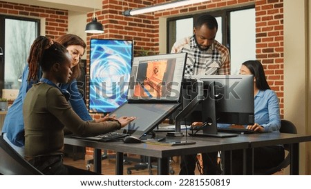 Multiethnic coworkers analyzing graphic developing technology and new production interface in agency studio. Artistic developer talking to team leader about faulty infographics software.