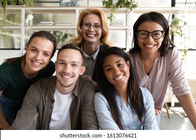 Multi-ethnic Diverse Ethnicity And Age Staff Members Smiling Look At Camera Gathered Together At Office Enjoy Distant Chat Webcam View, Meeting On-line, Team Building, Friendly Work Relations Concept
