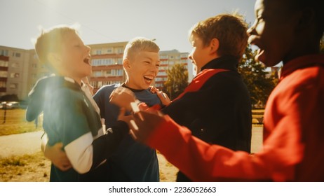 Multiethnic Diverse Friends Playing Soccer Outside in Urban Backyard. Young Boy Dribbling, Passing Opponents Alone with the Ball and Scoring a Goal. Football Players Hug and Celebrate. - Powered by Shutterstock